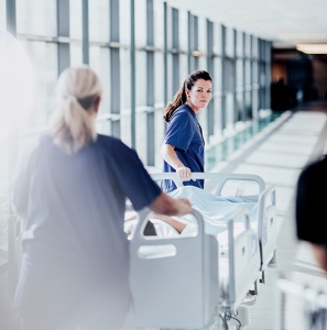 Nurses with patient in bed